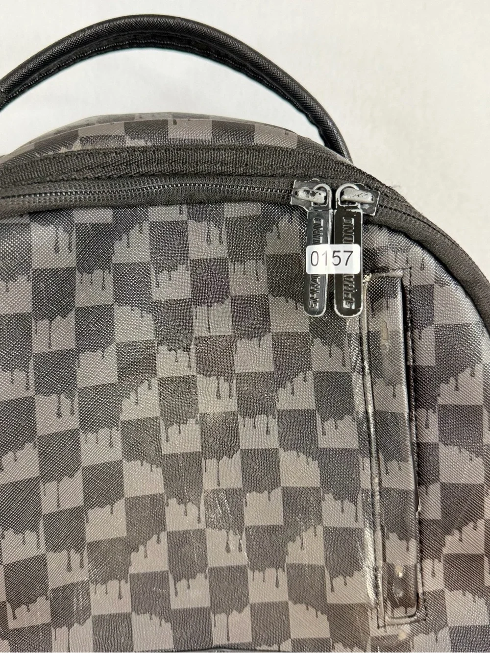 Sprayground Black Checkered Backpack with White and Red Shark Graphic